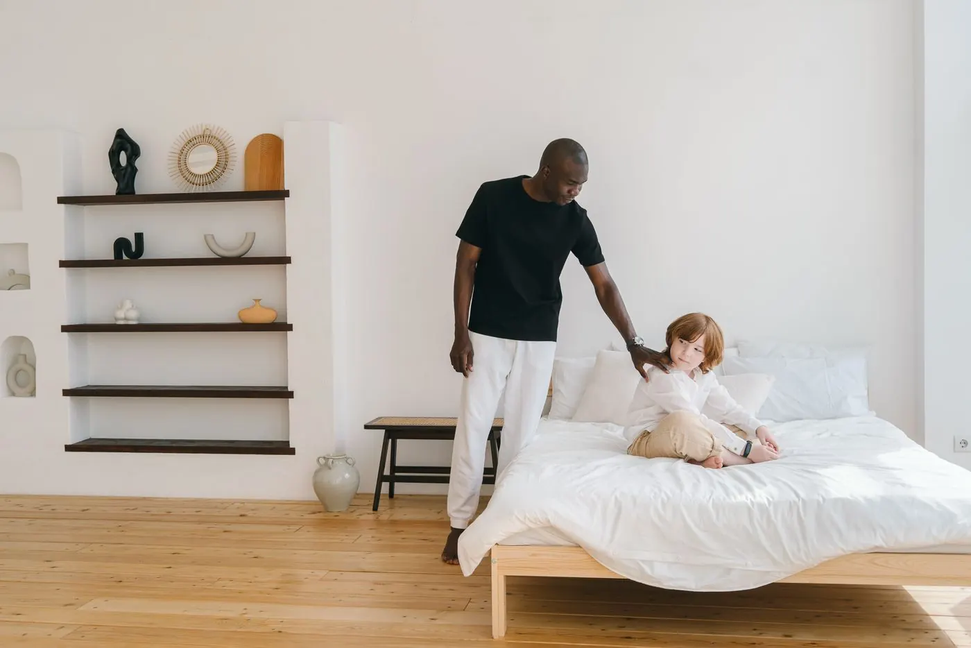 A support professional helping a child in a bright bedroom
